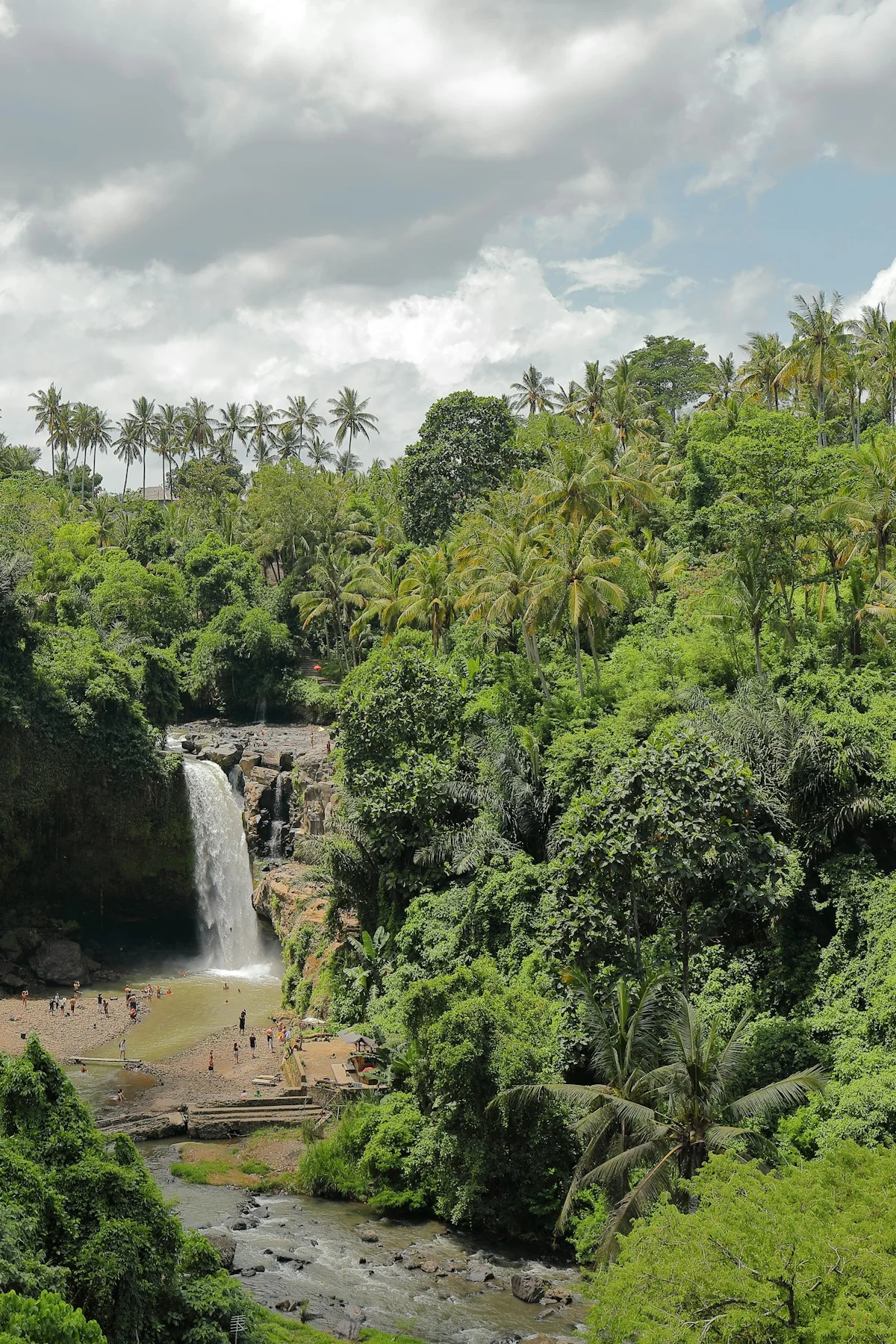 Tegenungan Waterfall surrounded by tropical forest in Bali